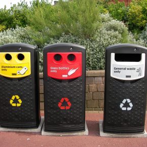 Three recycling bins used for different materials.