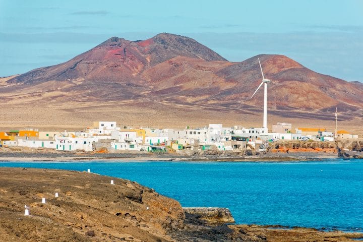 A wind turbine generating power for a remote village.