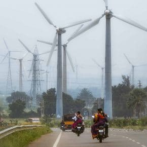 Wind turbines installed next to a highway in Tamil Nadu, India.