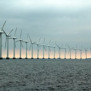 A collection of wind turbines at sea.