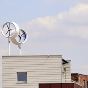 Two wind turbines fitted to the roof of a house.