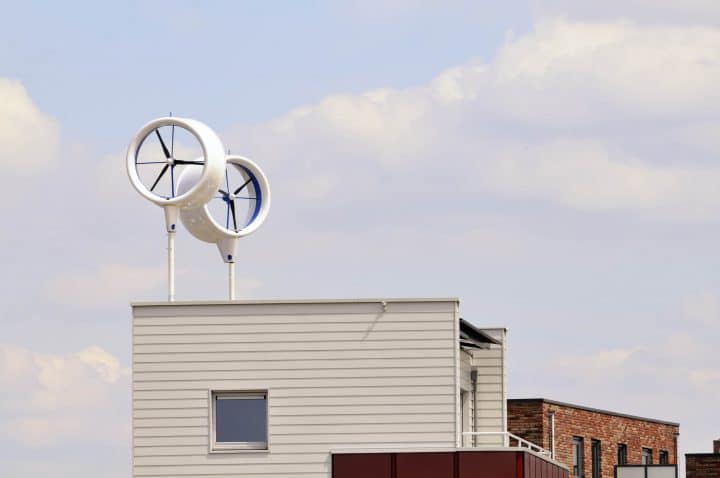 Two wind turbines fitted to the roof of a house.