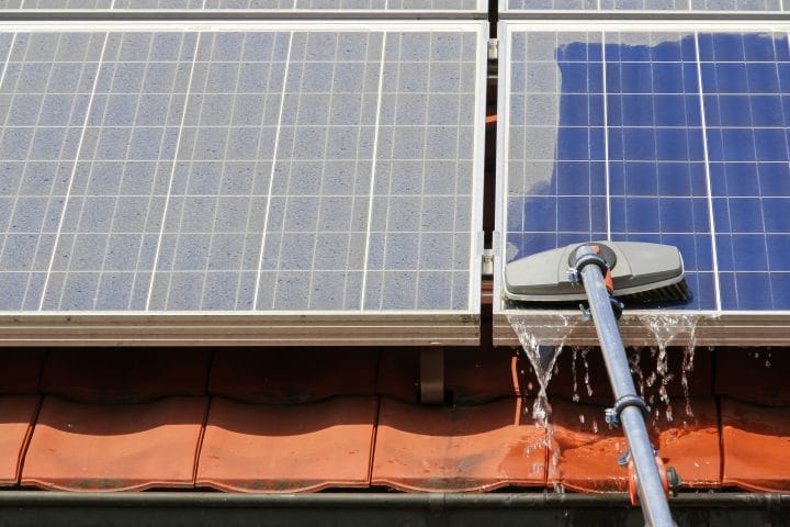 Somebody cleaning a solar panel.