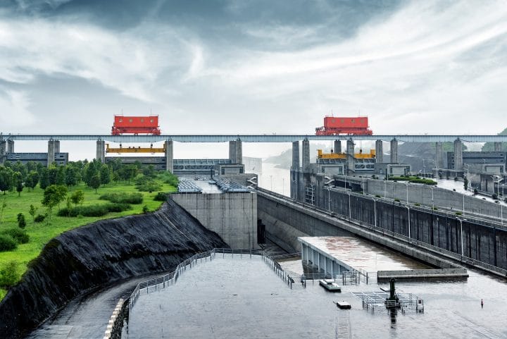 The Three Gorges Dam on the Yangtze River in China surrounded by vegetation.